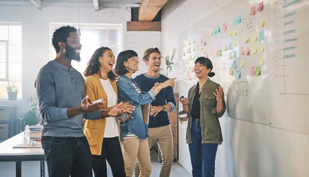Group of people in a bright office room sharing ideas and having fun during a team meeting in the afternoon