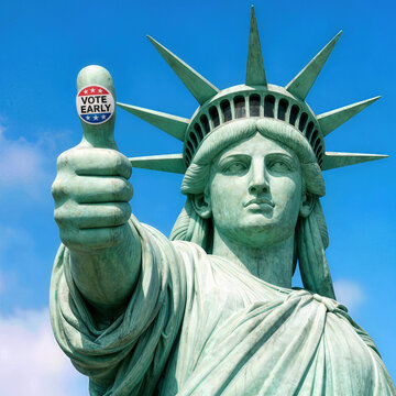 Bright close-up of the Statue of Liberty, proudly displaying an election "Vote Early" sticker on her thumb, framed by a clear blue sky