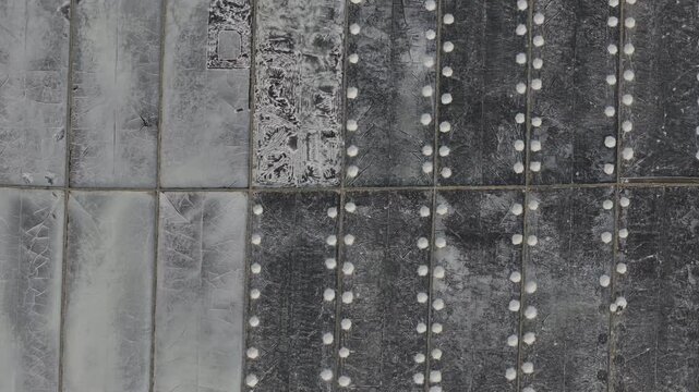 Aerial drone footage of Phuong Cuu Salt Fields in Khanh Hoa, Vietnam, showcasing traditional sea salt production, geometric salt ponds, coastal landscape and sustainable local industry.