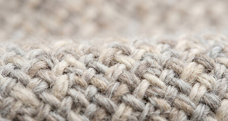 Fototapeta premium Extreme close-up of a chunky knit wool fabric texture in neutral beige tones