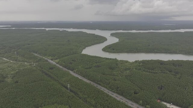 Aerial drone footage of Can Gio Mangrove Forest and winding rivers in Ho Chi Minh City, Vietnam, showcasing UNESCO biosphere reserve, lush wetlands and pristine tropical landscape.