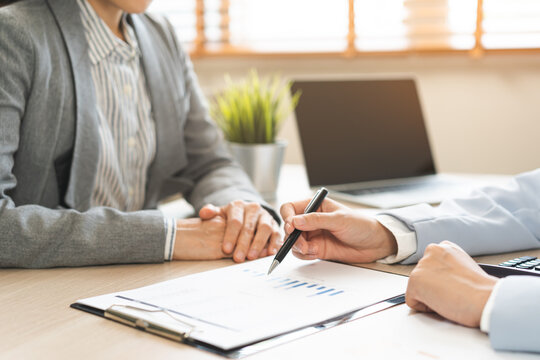 Business meeting, asian group brainstorm analysis on graph data of cost plan. financial consult planning investor asses and present to client, client and advisor review investment strategy in office.