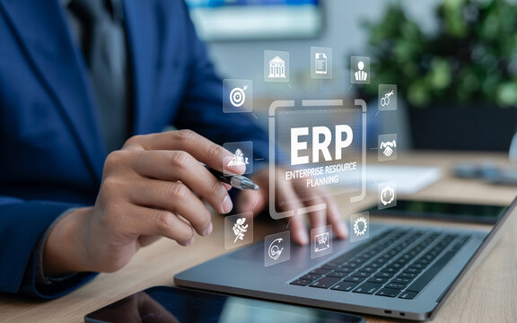 Business professional using laptop with virtual erp enterprise resource planning interface overlay.
