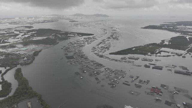 Aerial drone footage of oyster farming in Long Son, Ho Chi Minh City, Vietnam, showcasing traditional aquaculture, floating oyster farms, coastal fishing industry and sustainable seafood production.