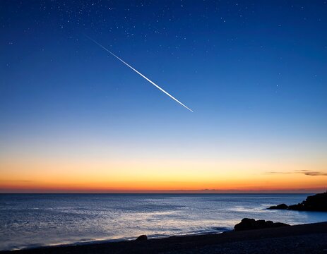 Contrail streaking across the evening sky over ocean.