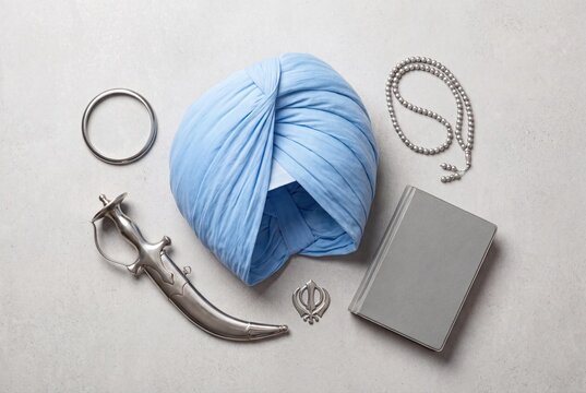 Sikh religious symbols with blue turban, kirpan,kara and holy book