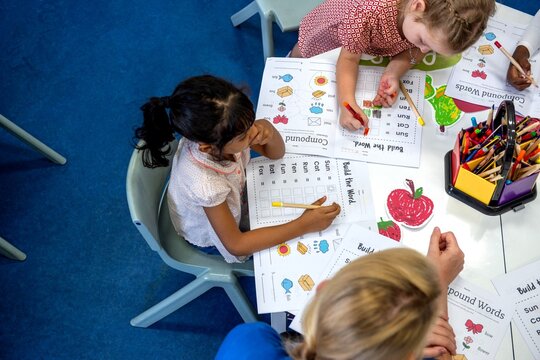 Children learning with colorful worksheets.