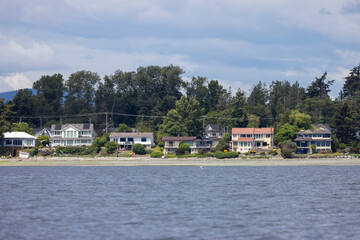 Fototapeta premium Waterfront Homes Along a Quiet Shoreline in Sidney on Vancouver Island BC Canada