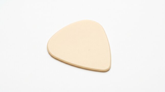 Beige guitar pick resting on white textured background with textured surface displays beige entertainment performance instrument minimalist with equipment