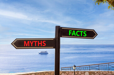 Obraz premium Facts or myths words symbol. Concept words Myths and Facts on beautiful black road sign. Beautiful blue sky background. Business and facts or myths concept. Copy space.