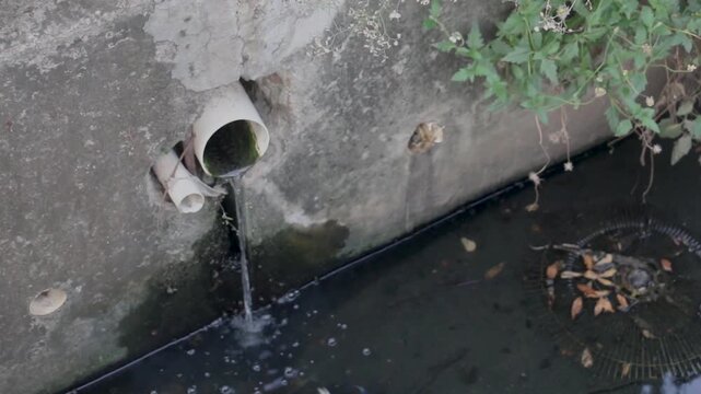 Polluted Urban Drainage Pipe Discharging Wastewater into Concrete Canal with Stagnant Water, Environmental Pollution, Poor Sanitation and Stormwater Drainage Infrastructure