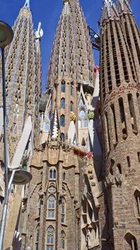 Barcelona, Spain. June 13, 2026, Intricate architectural details of the Sagrada Familia's towers, designed by Antoni Gaudi, reaching towards a clear blue sky in Barcelona, Spain