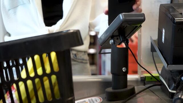 Checkout Experience Captured: A Glimpse at a Retail Transaction with a Focus on the Register and Baskets, Highlighting the Importance of Efficient Service for Busy Customers