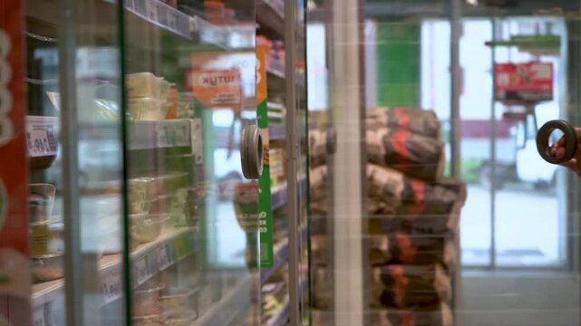 A Person's Hand Reaches for a Snack in a Modern Convenience Store, Highlighting the Convenience of Self-Service Food Options