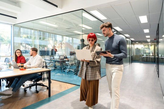 Colleagues collaborating in modern office with technology