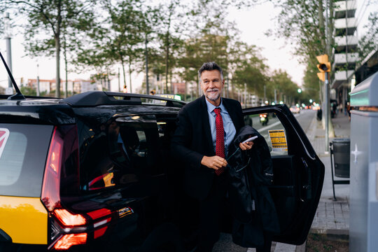 A man getting out of a taxi