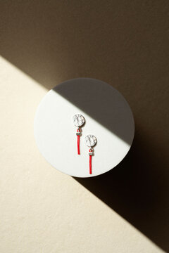 Silver Coin Earrings with Red Tassel on Geometric Prop