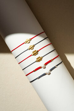 Mixed dainty grey and red cord bracelet Bracelets on Geometric Display