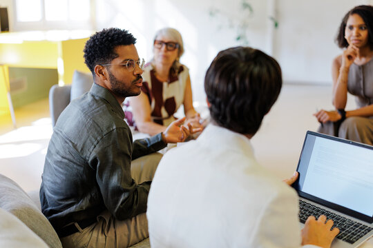 Diverse group of people discussing ideas in a comfortable office