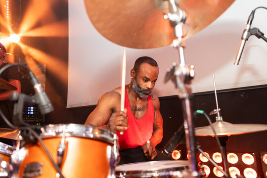 African american male drummer performing live on stage