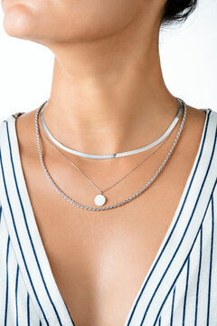 Woman Wearing Layered Silver Necklaces