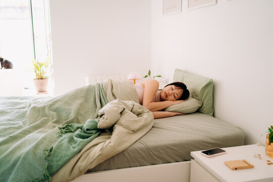 A woman sleeping in a bed