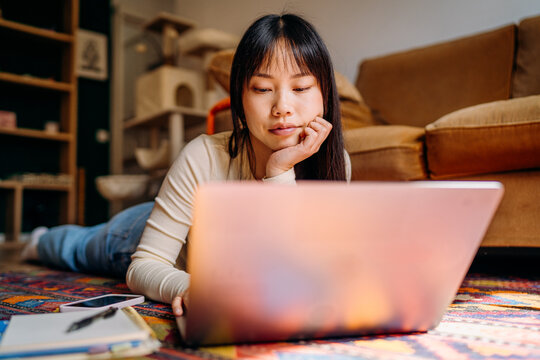 A woman using a laptop at home