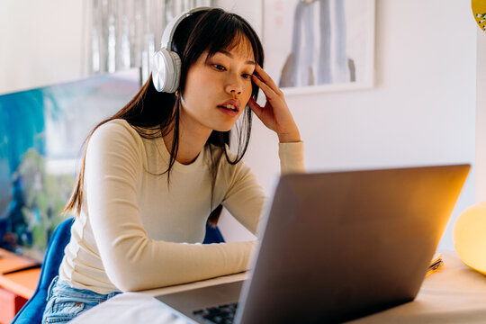 A woman using a laptop at home