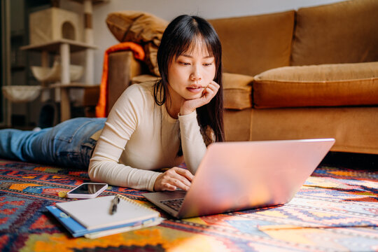 A woman using a laptop at home