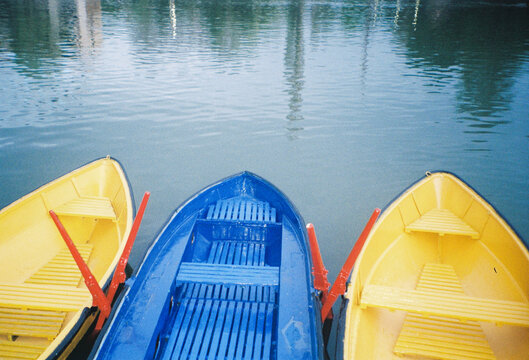 Colorful Boats Docked Near Calm Water in a Marina During Midday