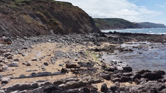 Secluded rock and sandy beach on Southern part of Widemouth Bay Cornwall