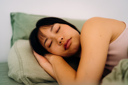 A woman sleeping in a bed