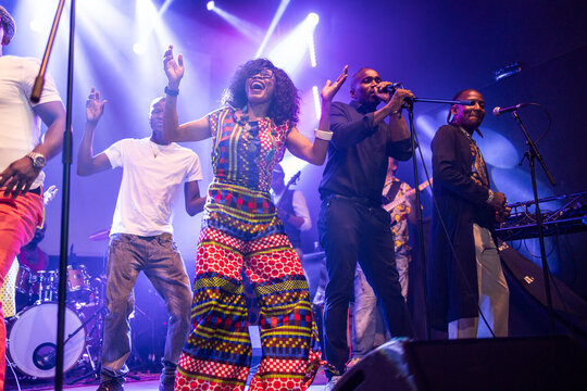 African musicians performing live on stage with vibrant energy