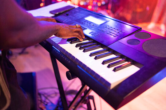 Musician playing electronic keyboard at live event