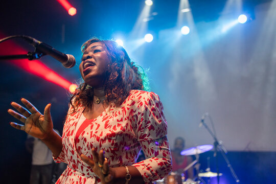 African female singer performing passionately at live concert