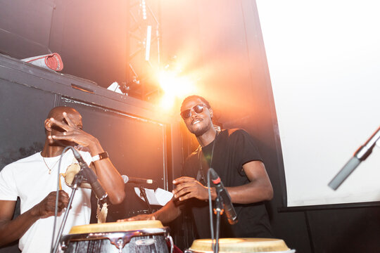 Musicians performing percussion instruments live on stage