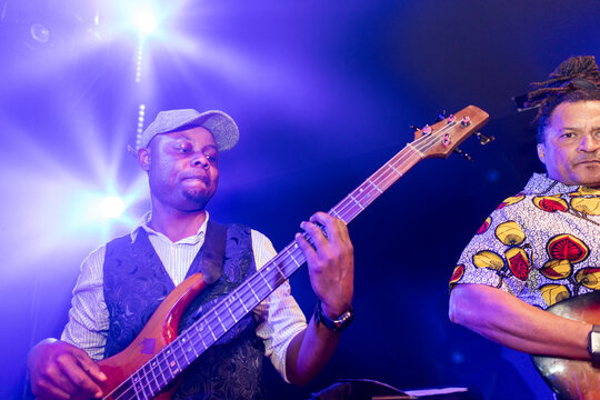 African american bass player performing live on stage