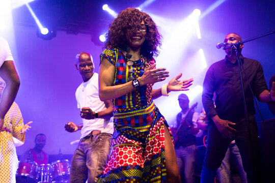 Vibrant african woman happily dancing enjoying live music
