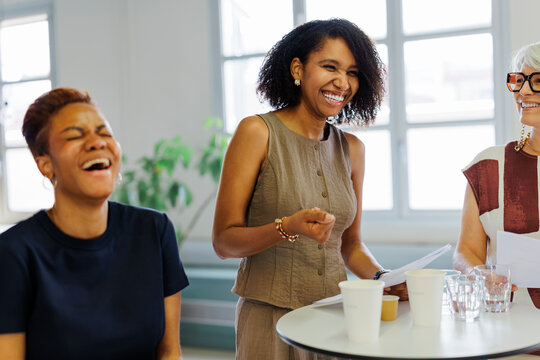 Businesswomen laughing during an office presentation