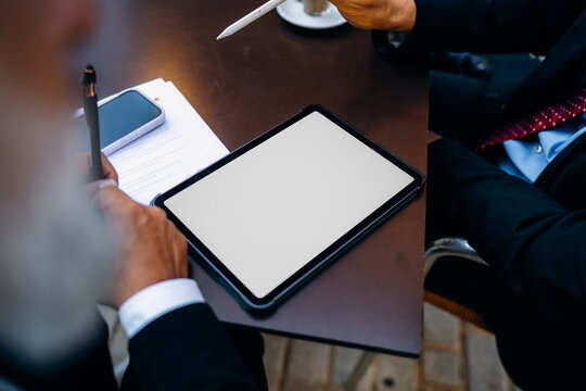 Businessmen use a tablet with a white screen