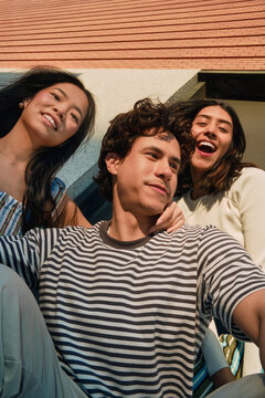 Three Friends Laughing in Low Angle Selfie