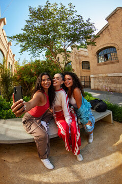 Friends take selfie in outdoor setting during sunny day