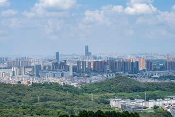 Fototapeta premium A view of the cityscape of Guzhen, Zhongshan City, seen from Baishuidai Scenic Area in Jiangmen City, China.