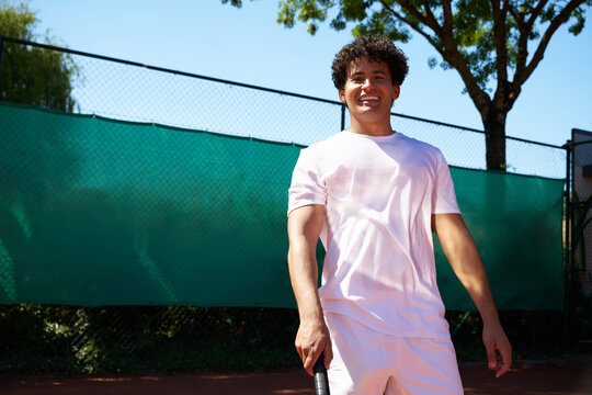 Young Man Stands on Tennis Court Ready for Match