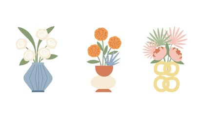 Cute collection of three ceramic flower vases in minimalist Scandinavian style isolated on a white background. © Sumi
