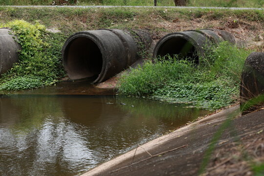Concrete circular run-off pipe discharging water. sewage pipe polluting the river. Sewage or domestic wastewater or municipal wastewater that is product by community of people.