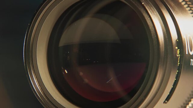 Slomo close up of cinematography glass equipment of an expensive cinema lens for large format cameras and camera technology as rear and front elements show iris, aperture, focus, and distance marks 4k
