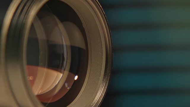 Slomo close up of cinematography glass equipment of an expensive cinema lens for large format cameras and camera technology as rear and front elements show iris, aperture, focus, and distance marks 4k