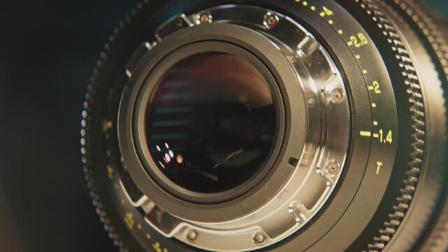 Slomo close up of cinematography glass equipment of an expensive cinema lens for large format cameras and camera technology as rear and front elements show iris, aperture, focus, and distance marks 4k