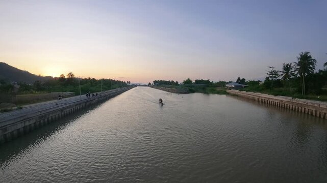 Slow Motion of Two Fishermen in a Boat at Sunset